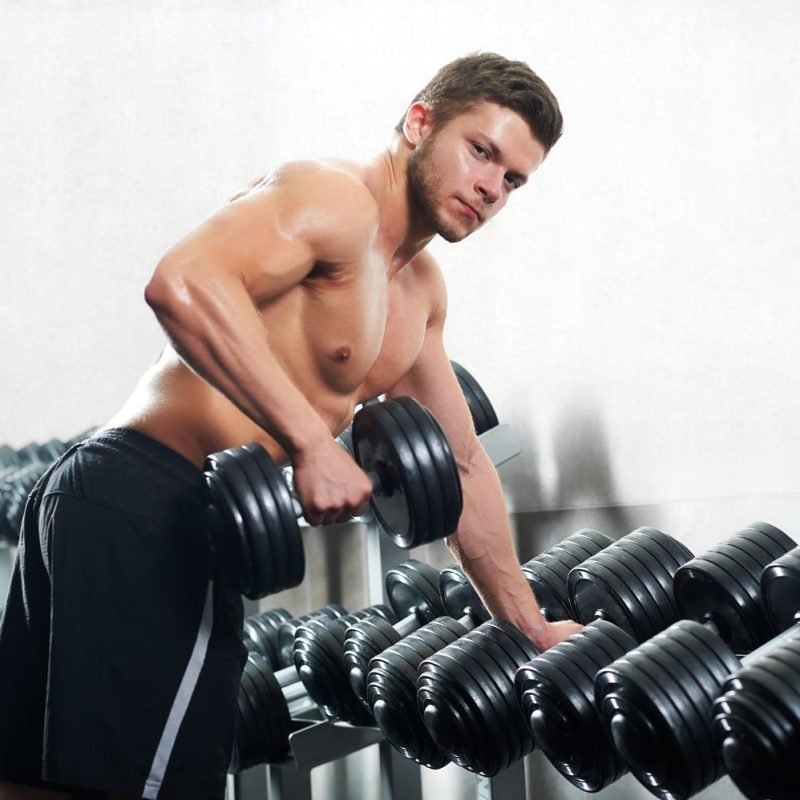 handsome-young-athlete-working-out-at-the-gym-54XWTB4.jpg